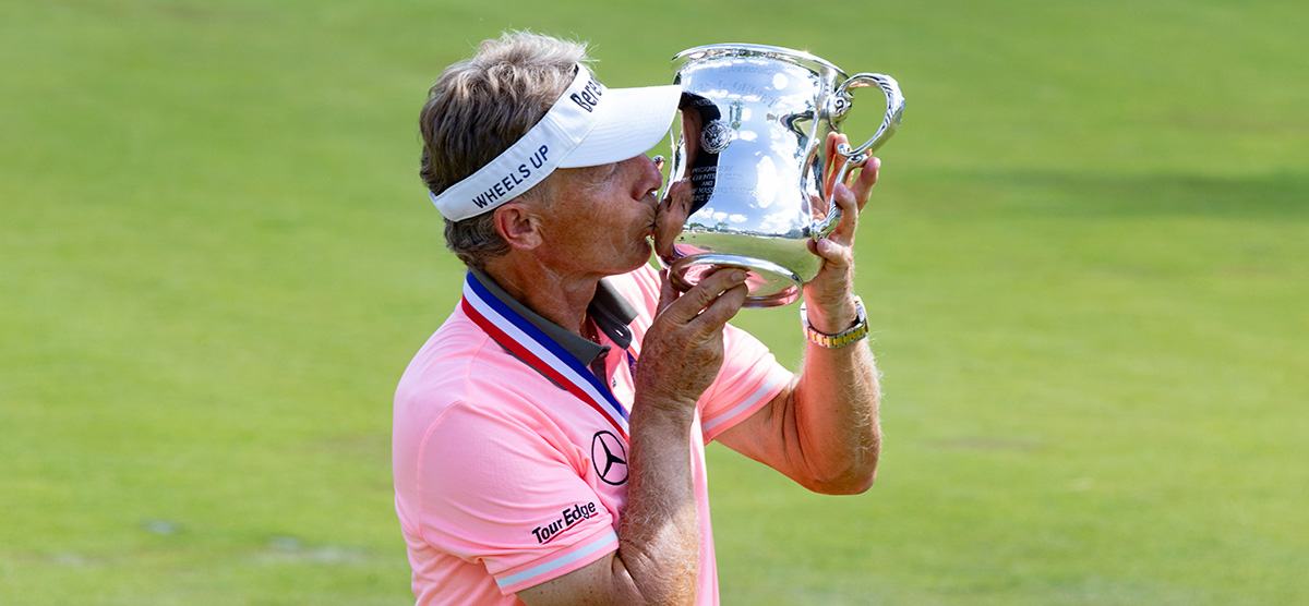 Bernhard Langer kissing the 2023 U.S. Senior Open championship trophy