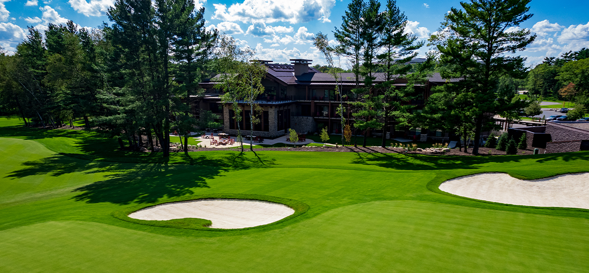 The Inn at SentryWorld next to a fairway on the golf course