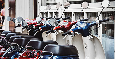 A row of scooters in different colors