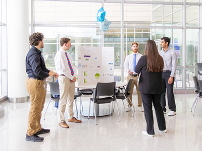 Interns presenting during a case competition