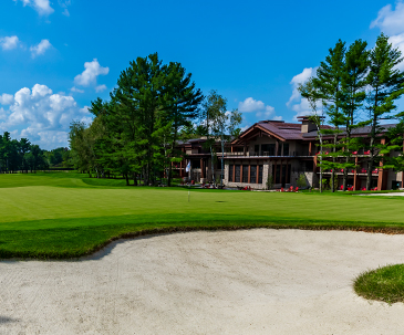 Sand trap next to a putting green behind The Inn at SentryWorld