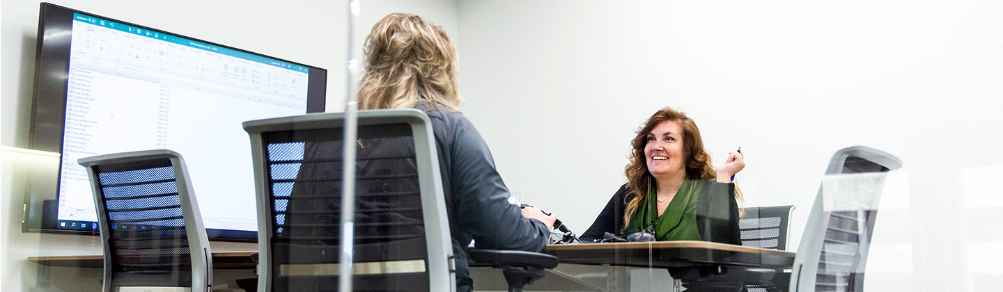 Two people sitting in a Sentry office having a conversation