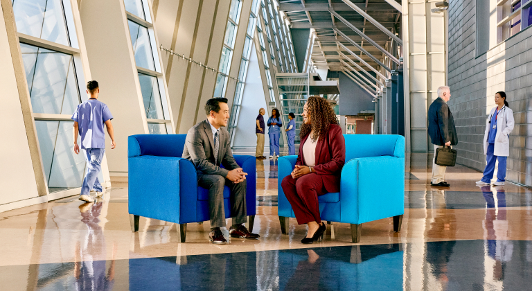 Two healthcare executives sitting in Sentry blue chairs.