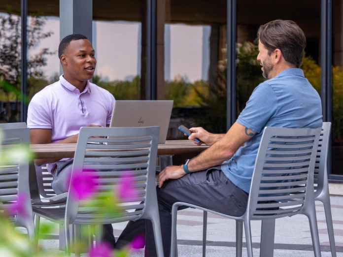 Associates meeting in the courtyard at the Sentry home office