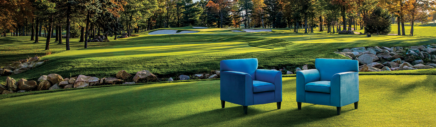 Two blue colored chairs on the SentryWorld golf course