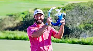 Jon Rahm holding The Sentry tournament trophy