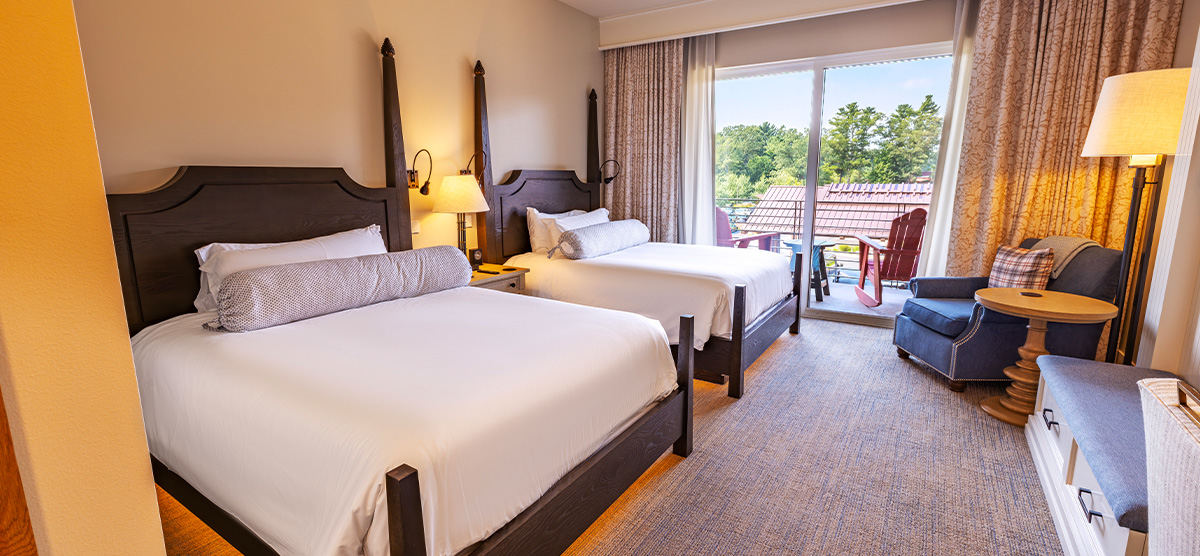 carousel-executive-queen-terrace-1-1200x556 A room with two queen beds and a patio door to a terrace.