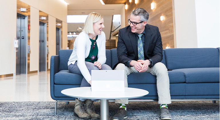 Two associates collaborating in the lobby at the Division Street office in Stevens Point, Wisconsin.