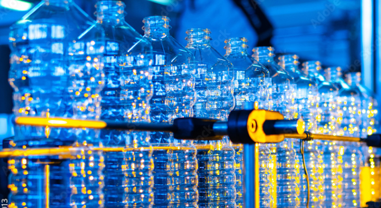 Plastic bottles on conveyor belt.