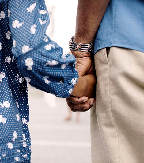 Close up of two people holding hands