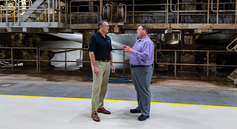 Two men talking in an industrial setting