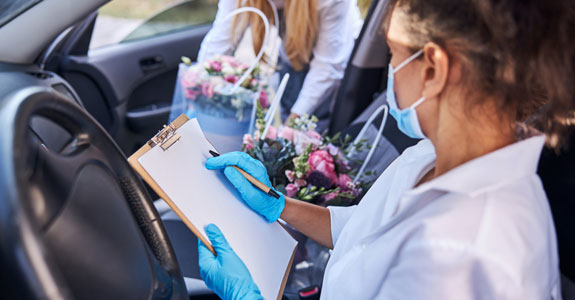 Someone in a car delivering flowers