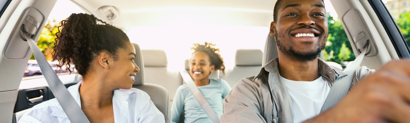 Happy family driving in their car.