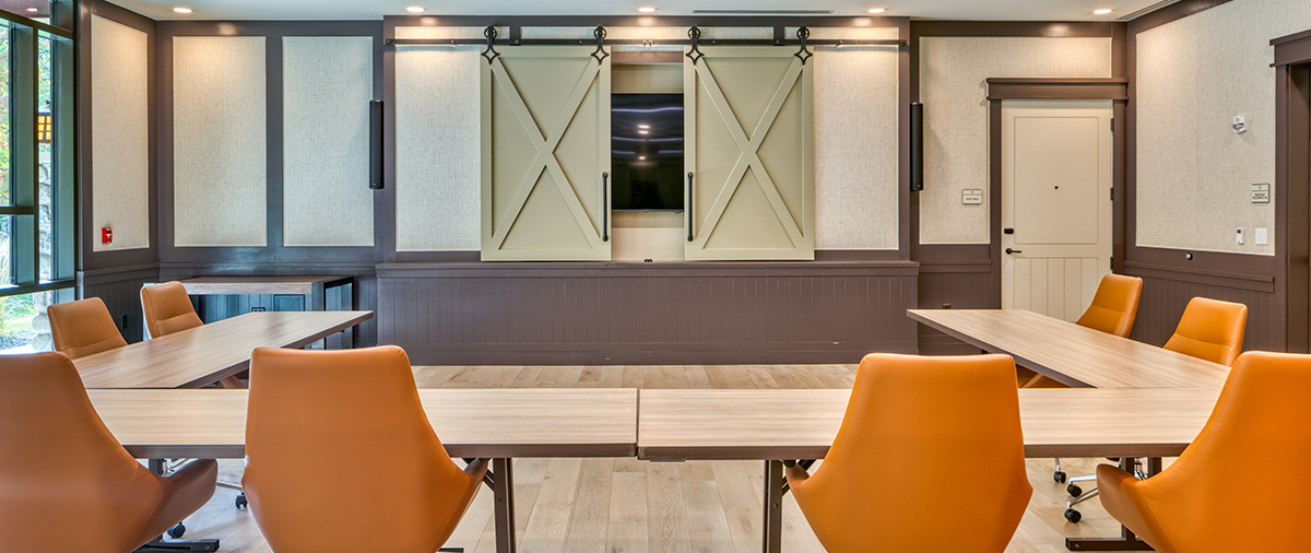 U-shaped table with chairs facing the TV in a meeting room