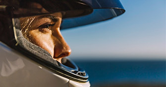 Close-up of woman wearing motorcycle helmet