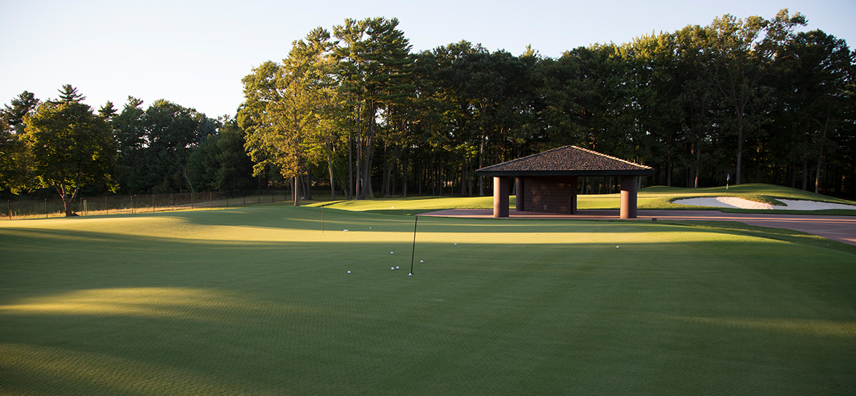 Practice putting green with golf balls around a pin at SentryWorld