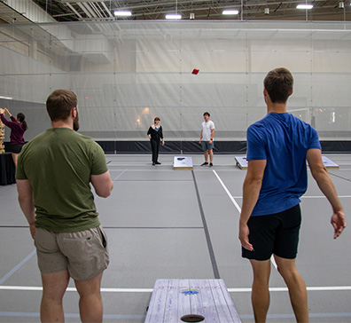 Player throwing a bean bag on the courts in the SentryWorld fieldhouse