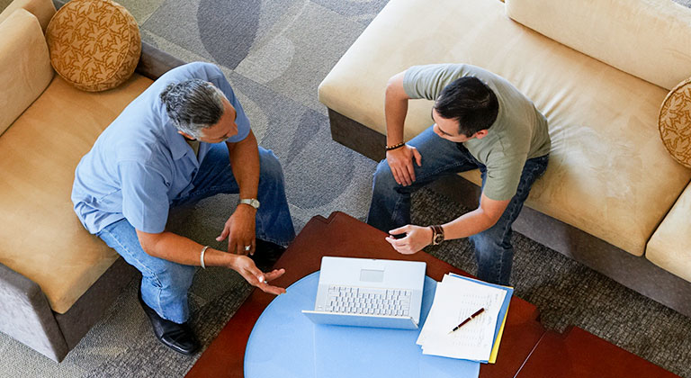 Aerial view of two business men seated in meeting