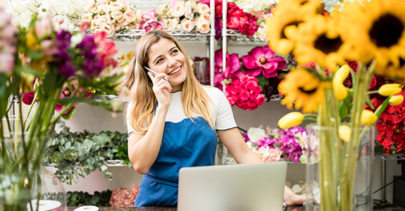 woman on the phone working in a floral shop