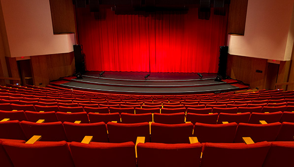 Sentry Theater stage with red curtain and red seats