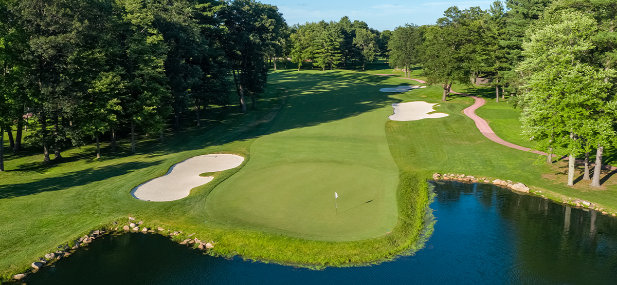 Aerial view of the putting green and water hazard on the seventeenth hole at SentryWorld