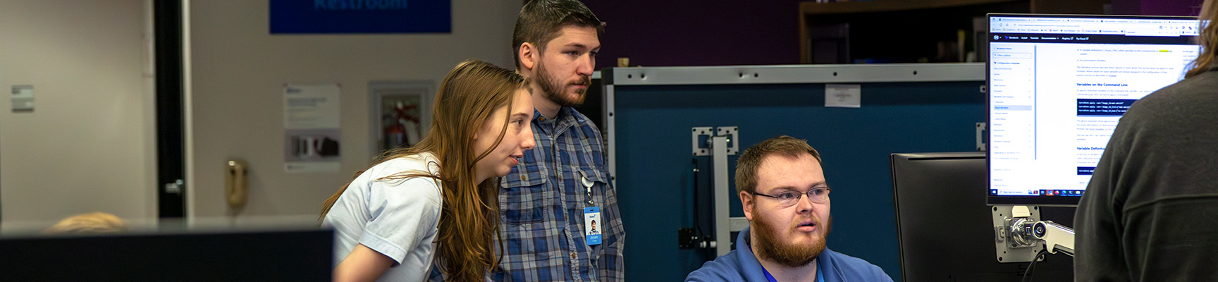 Three co-op students working on a project at the Stevens Point Sentry co-op location.