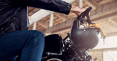 Close-up shot of a man sitting on a motorcycle