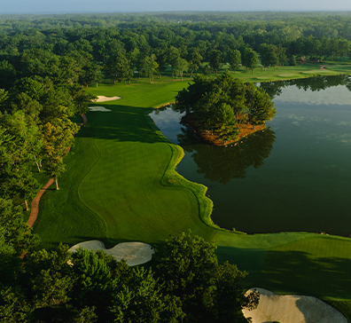 image-card-golf-sentryworld-396x364 SentryWorld golf course green and pond from above.