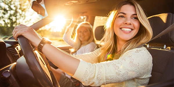 what-is-safest-car-for-families-resource-carousel2-rect two teens happily driving in a car