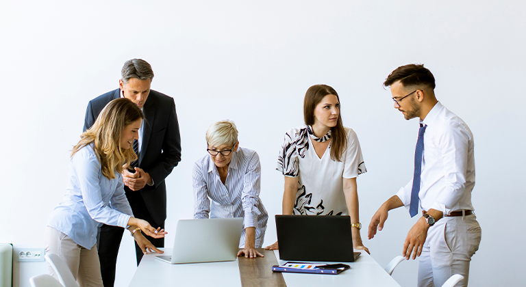 Group of people looking at laptops