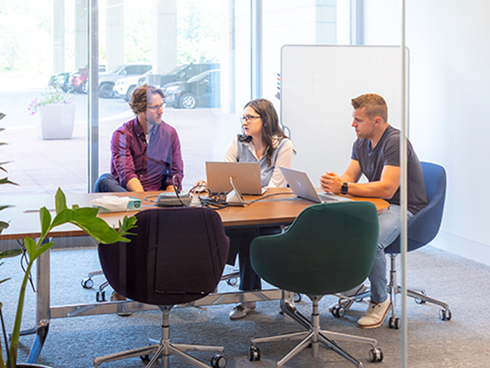 Members of the Underwriting team meeting at Sentry home office.