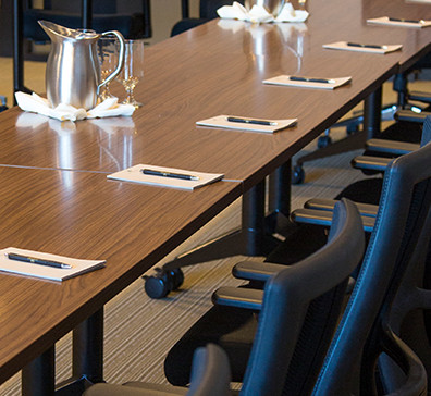 Long table with notepads and pens set for a meeting at SentryWorld