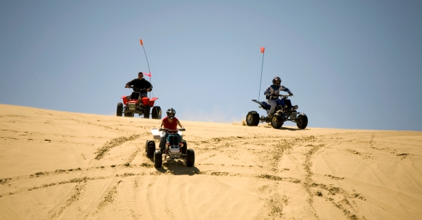 ATV riders on sand dunes