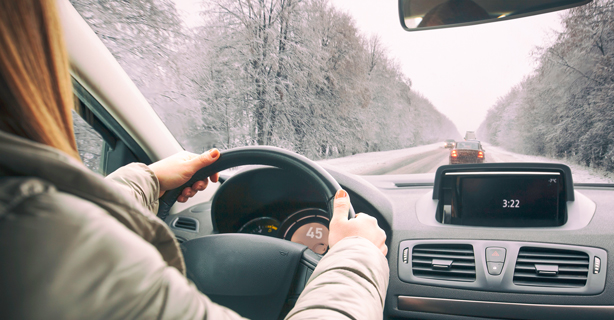 Person driving car on a snow-covered road