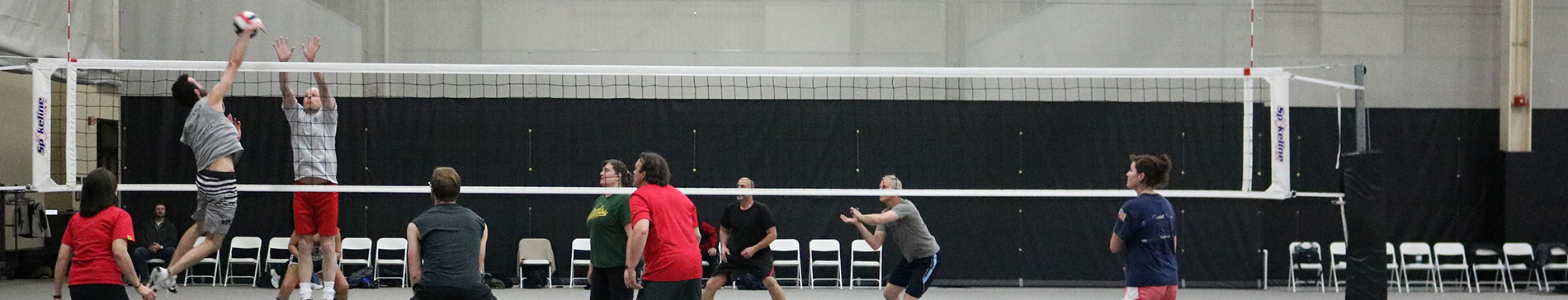 People playing volleyball in the fieldhouse at SentryWorld