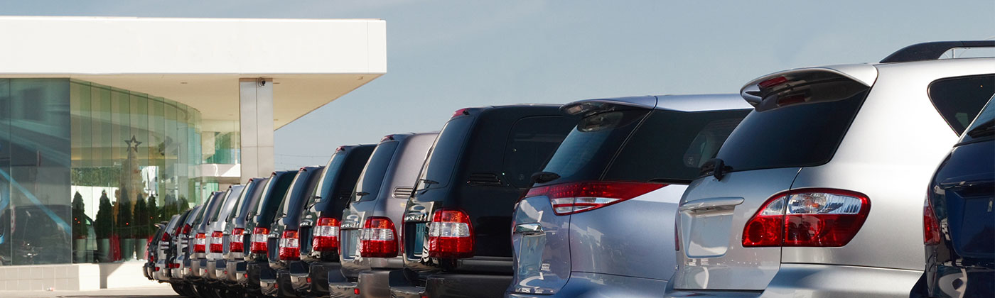 New cars parked in line at dealership