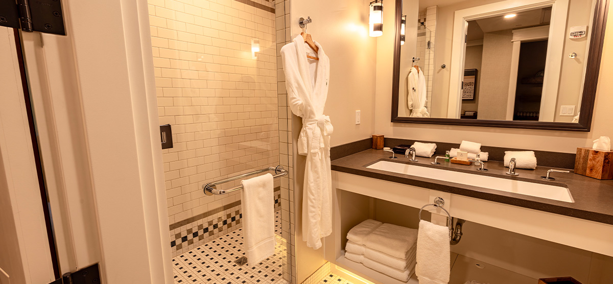 carousel-king-terrace-4-1200x556 Bathroom with large sink and bathrobe.