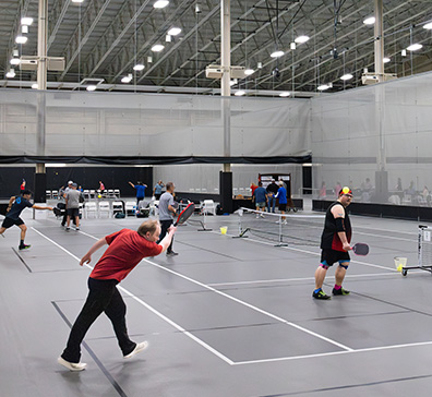 Games of pickleball being played in the SentryWorld field house.