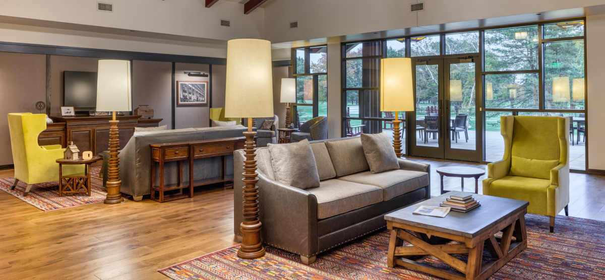 Livingroom seating with access to a large outdoor deck with additional seating. 