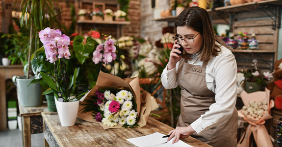 florist on the phone in floral shop