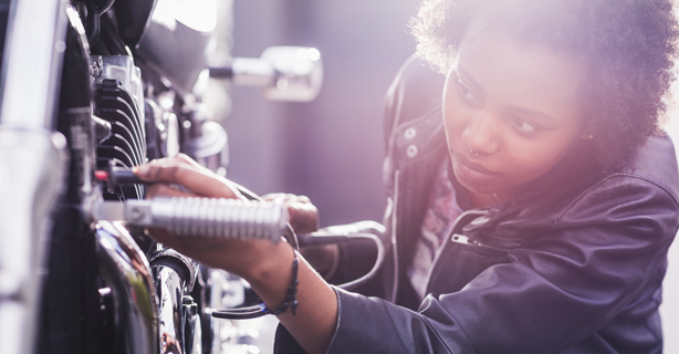 Woman inspecting motorcycle