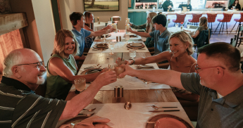 explore-the-library-345x182 The Library guests cheers glasses during dinner.