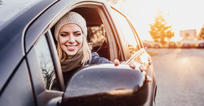 Woman adjusting her sideview mirror