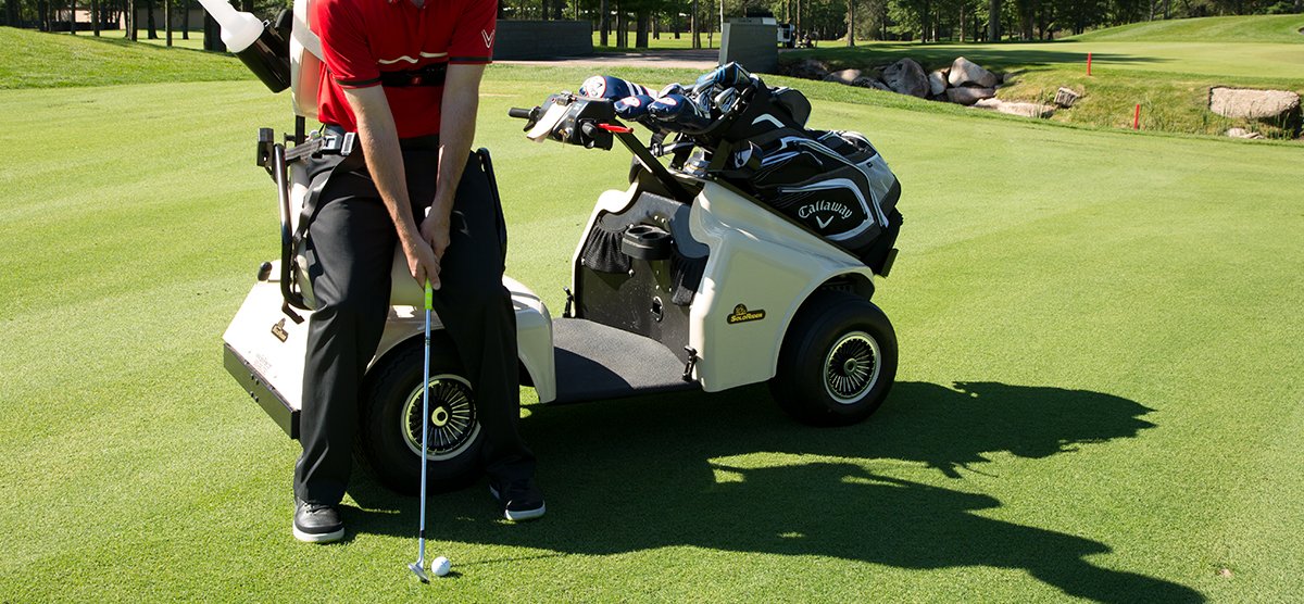 Player getting ready to hit from a handicap accessible golf cart at SentryWorld