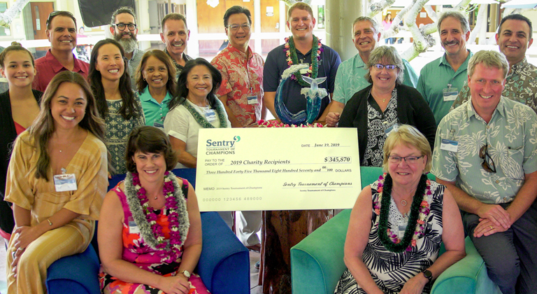 Sentry representatives gather around Sentry Tournament of Champions donation check