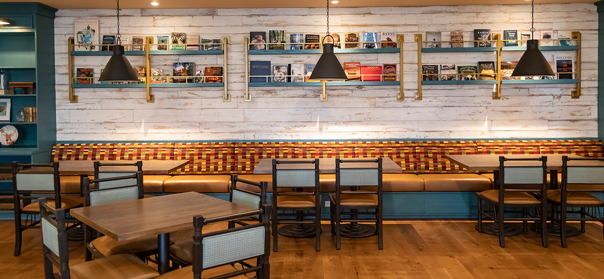 Booth and table seating with books to read in the Library Cafe