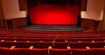 Sentry Theater stage with red curtain and red seats