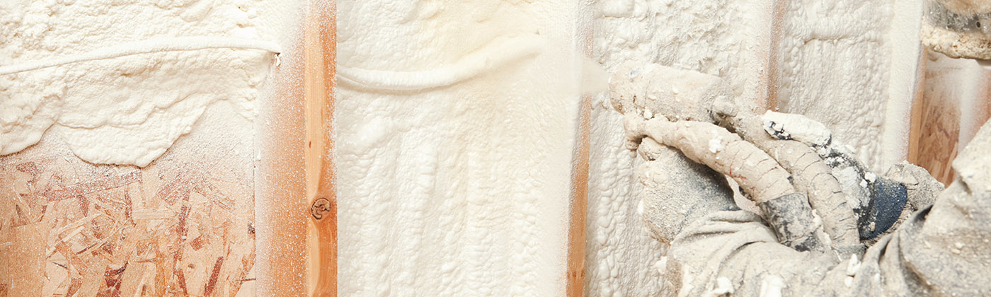 Construction worker spraying foam insulation