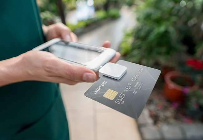 Someone using a tablet with a credit card reader