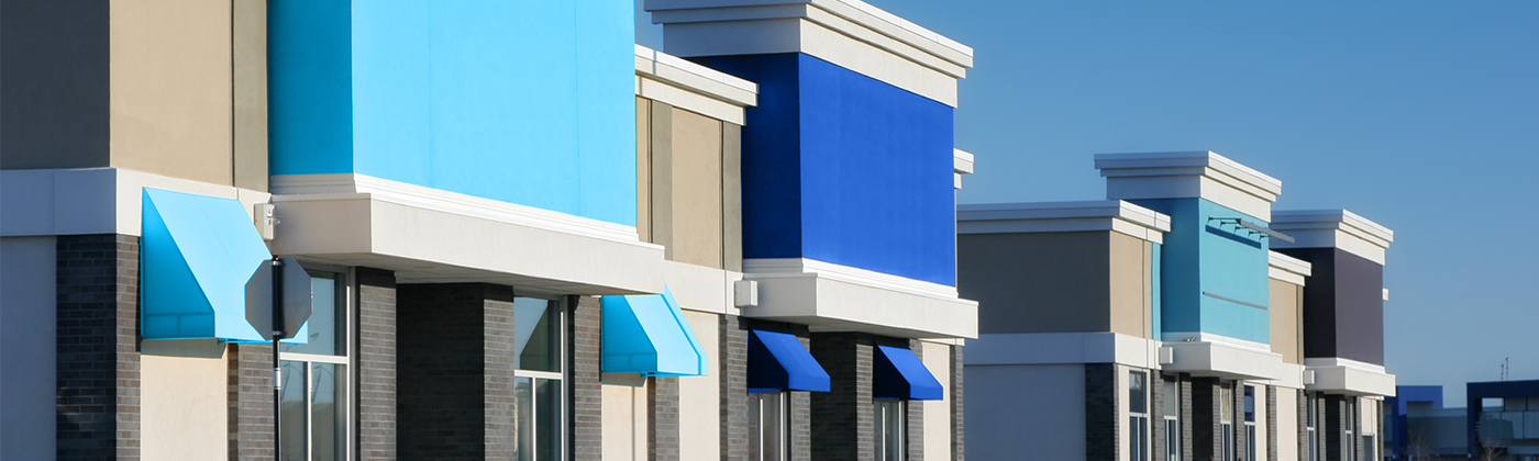 Line of storefronts in shopping center. 